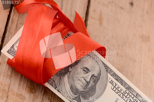 Image of american money and red ribbon