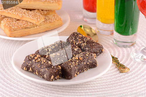 Image of chocolate sweet cake on white plate and juice