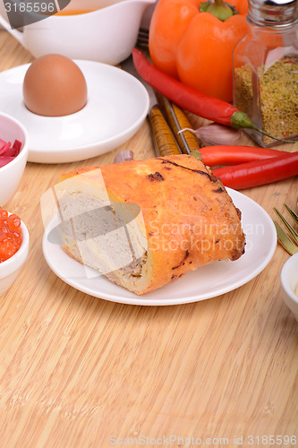 Image of Fresh meat on white plate and red pepper