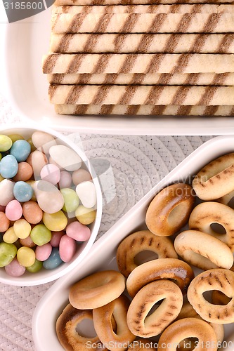 Image of sweet cake on white plate and candies
