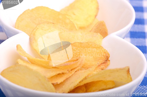 Image of Potato chips on white bowl, close up