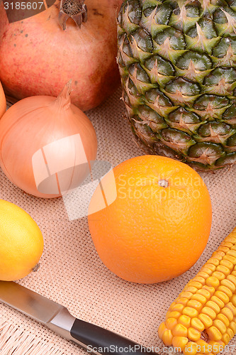 Image of fresh pineapple with corn and orange