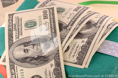 Image of american money dollars and green gift box
