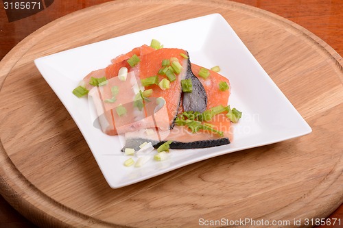 Image of Slice of red fish salmon on white plate