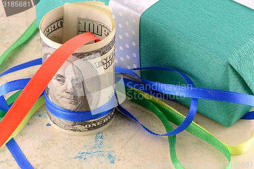 Image of american money dollars and green gift box