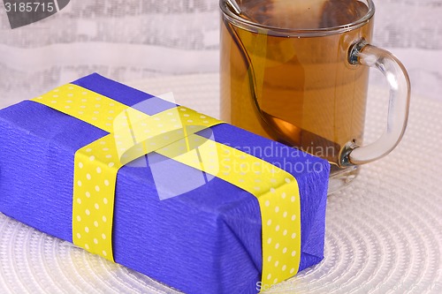 Image of glass cup of tea and gift box