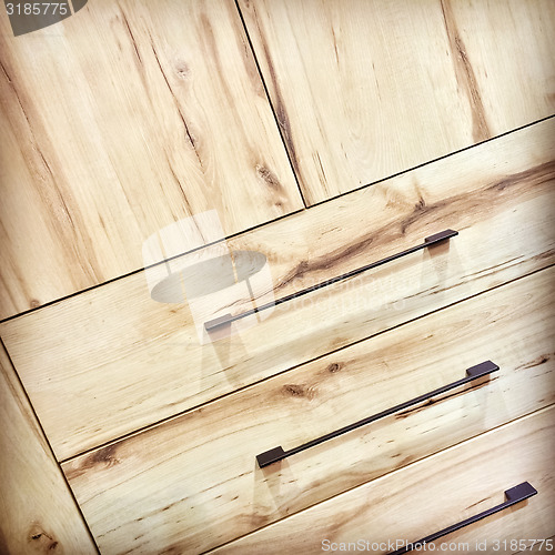 Image of Wooden dresser with metal handles