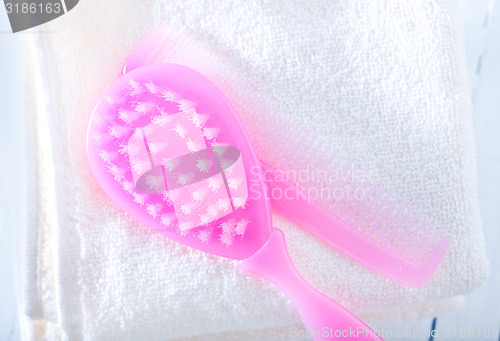 Image of hairs brushes and baby clothes