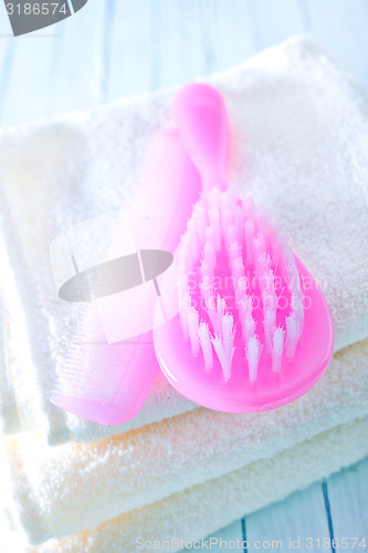 Image of hairs brushes and baby clothes
