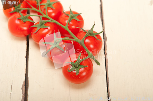 Image of fresh cherry tomatoes on a cluster