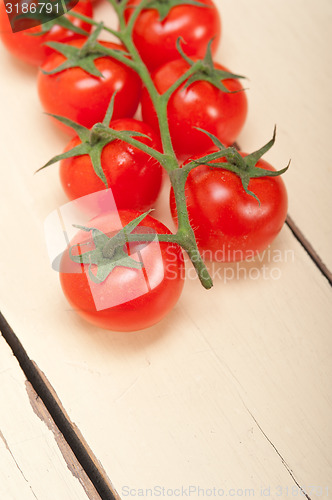 Image of fresh cherry tomatoes on a cluster