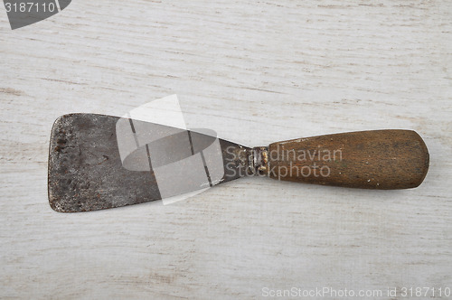 Image of Putty knife on wood