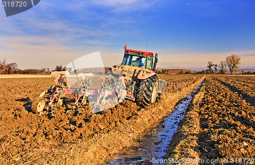 Image of Tractor plowing field