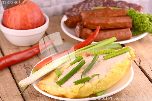Image of fresh salad with chicken chop and sausages on white plate