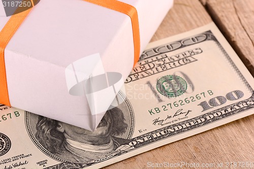 Image of american money with green gift box