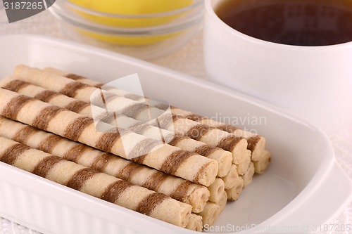 Image of A cup of tea with a cake
