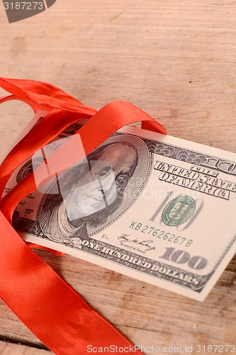 Image of american money and red ribbon