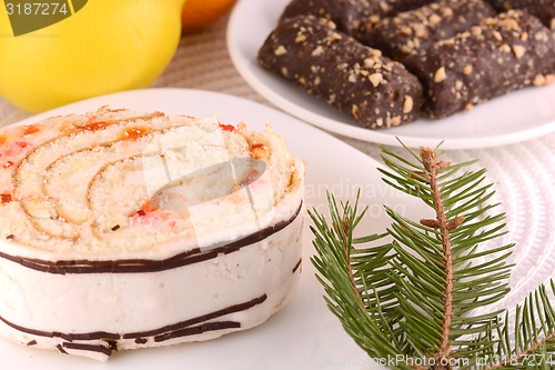 Image of sweet cake on white plate and fruits