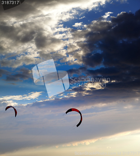 Image of Two silhouette of power kites at sunset sky