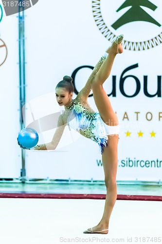 Image of Young beautiful girl shows exercise with ball