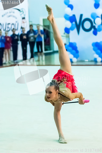 Image of Young attractive girl shows exercise with maces