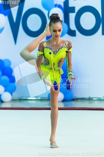 Image of Young pretty girl shows exercise with ball