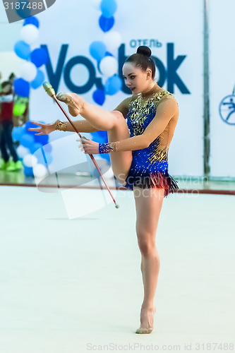 Image of Young pretty girl shows exercise with ball