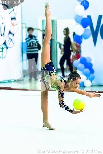 Image of Young beautiful girl shows exercise with ball