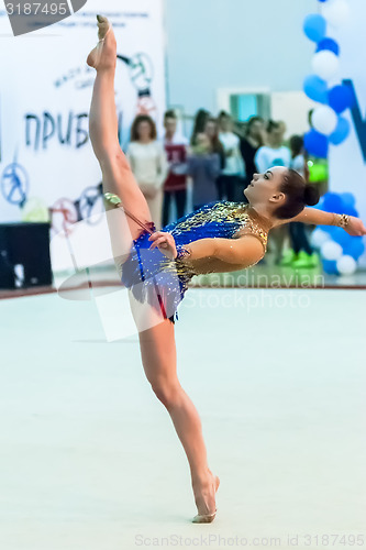 Image of Young pretty girl shows exercise with ball