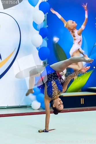 Image of Young pretty girl shows exercise with ball