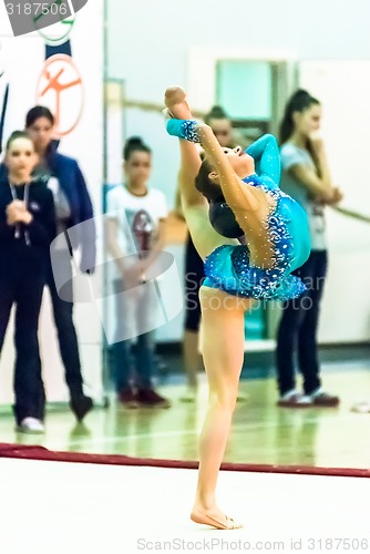 Image of Young beautiful girl shows exercise with ball