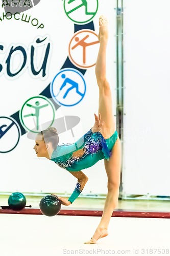 Image of Young beautiful girl shows exercise with ball