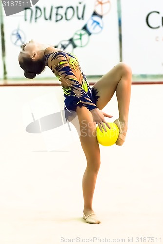 Image of Young beautiful girl shows exercise with ball