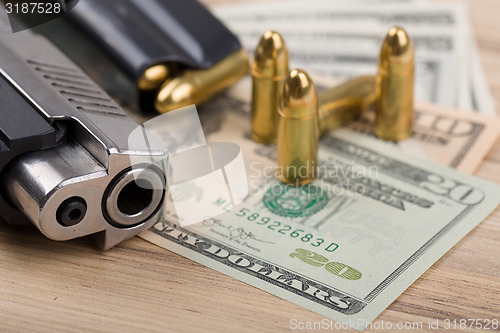 Image of gun with bullet on US dollar banknotes