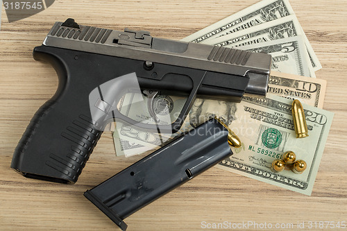 Image of gun with bullet on US dollar banknotes