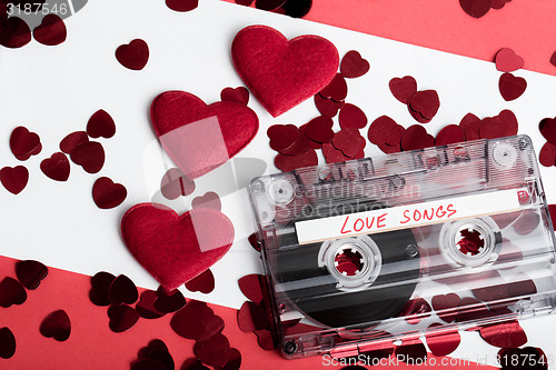 Image of Audio cassette tape on red backgound with fabric heart