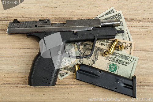 Image of gun with bullet on US dollar banknotes