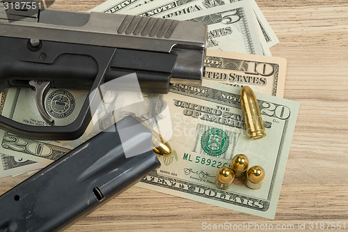 Image of gun with bullet on US dollar banknotes