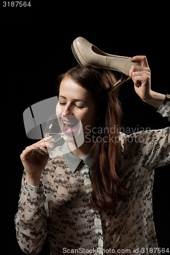 Image of beautiful young brunette woman holding a glass of white wine