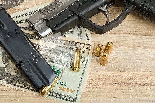 Image of gun with bullet on US dollar banknotes