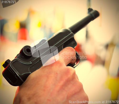 Image of Parabellum automatic pistol in a human hand