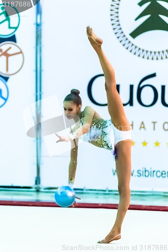 Image of Young pretty girl shows exercise with ball