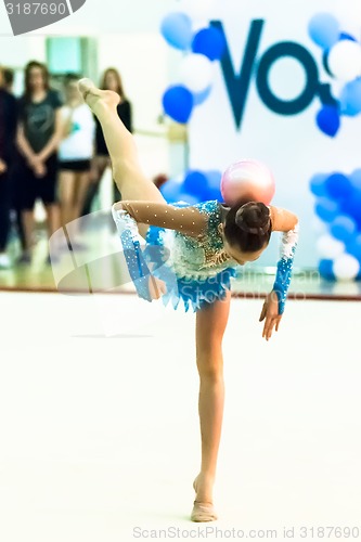 Image of Young beautiful girl shows exercise with ball