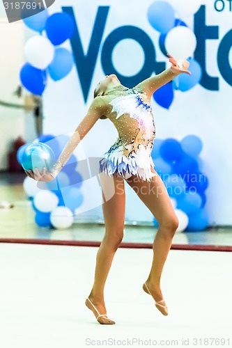 Image of Young pretty girl shows exercise with ball