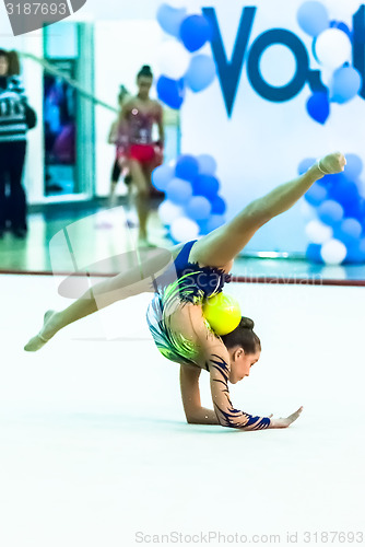 Image of Young beautiful girl shows exercise with ball