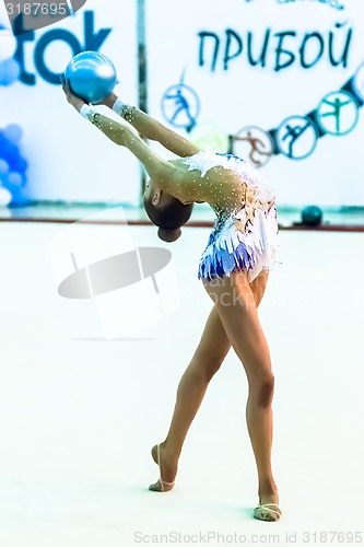 Image of Young attractive girl shows exercise with ball