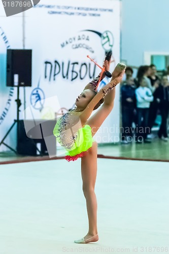 Image of Young beautiful girl shows exercise with maces