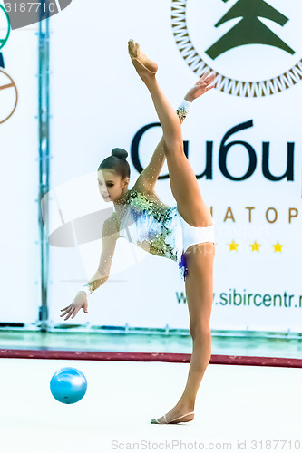 Image of Young beautiful girl shows exercise with ball