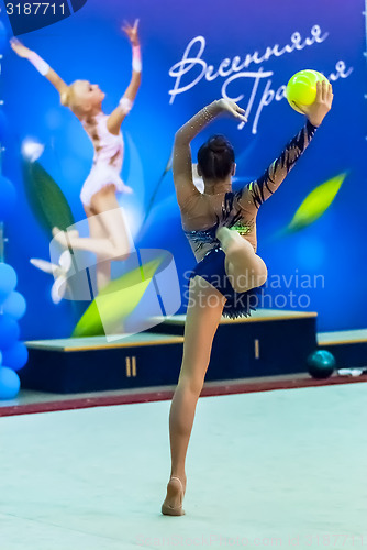 Image of Young beautiful girl shows exercise with ball