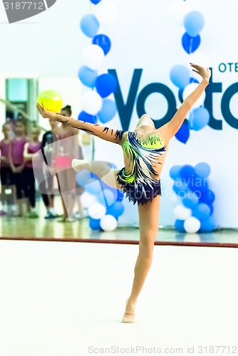 Image of Young beautiful girl shows exercise with ball